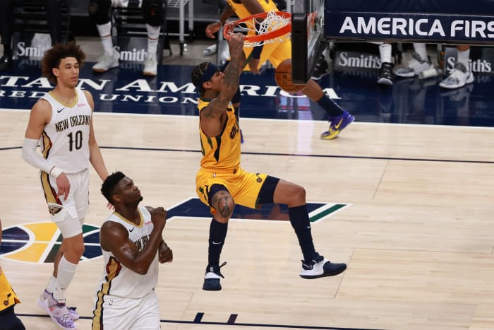 Jordan Clarkson (00) dunks over Zion Williamson (1)